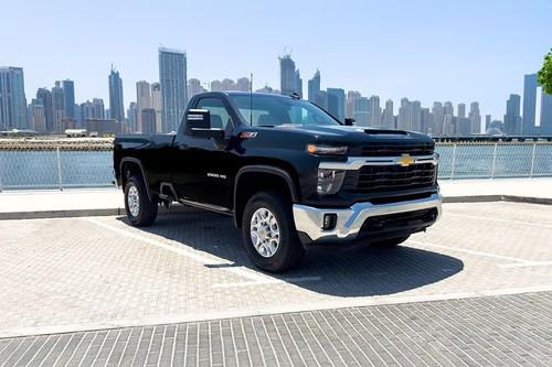Chevrolet Silverado HD 2026 Pickup Truck front right side angle view on city street. Chevrolet Silverado HD 2026 Pickup Truck front right side angle view on city street.