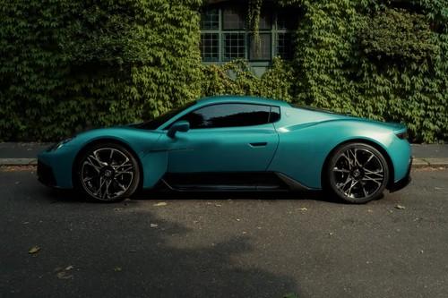 Maserati Mcpura 2026 ai aqua rainbow matte Coupe left side profile with alloy wheels Maserati Mcpura 2026 ai aqua rainbow matte Coupe left side profile with alloy wheels