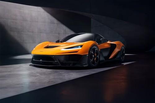 McLaren W1 Orange Coupe front right side angle view on city street McLaren W1 Orange Coupe front right side angle view on city street