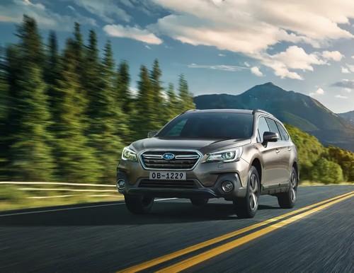 Subaru Outback SUV front left side angle view on a mountain road Subaru Outback SUV front left side angle view on a mountain road