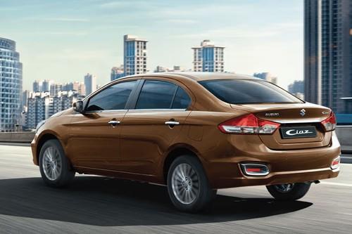 Suzuki Ciaz 2026 Brown Sedan Rear Right Side Highlighting Taillights and Tailgate Suzuki Ciaz 2026 Brown Sedan Rear Right Side Highlighting Taillights and Tailgate
